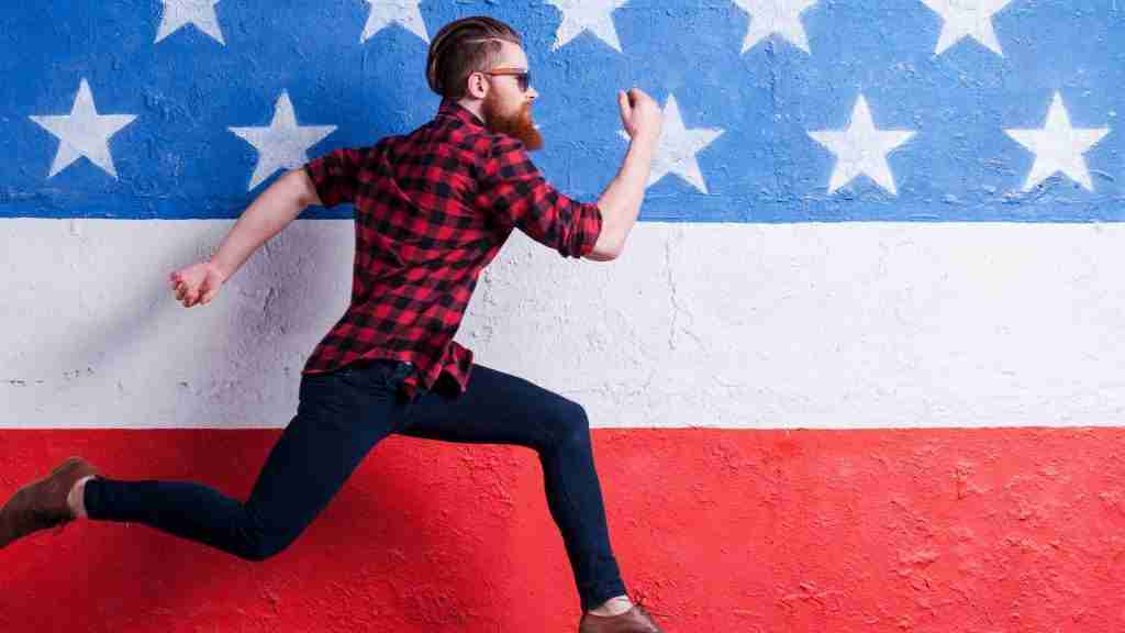 Man running with American flag in background