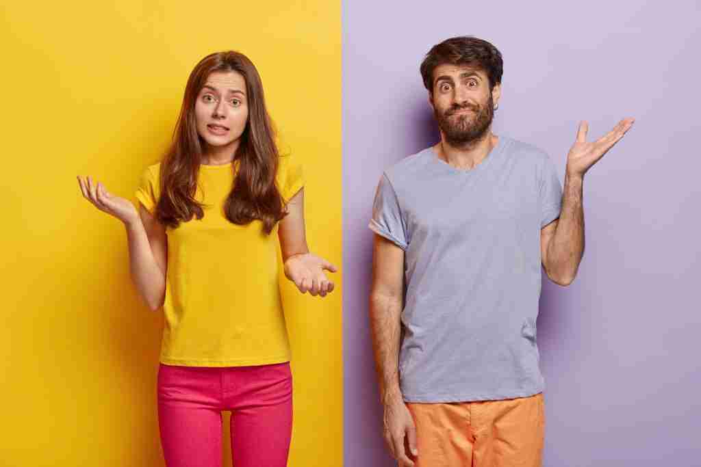 Indifferent unbothered woman and man spread hands sideways, have no idea, dressed in casual outfit,