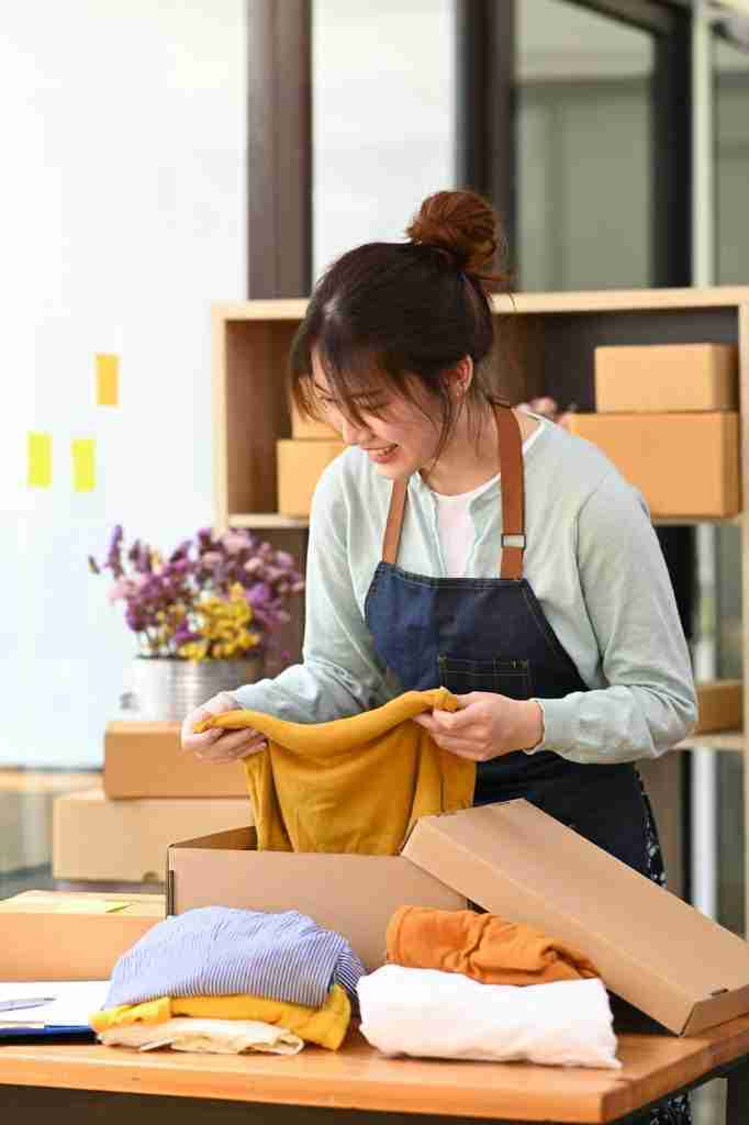 Startup small business owner packing parcel boxes for shipment. E-commerce, Online selling concept.