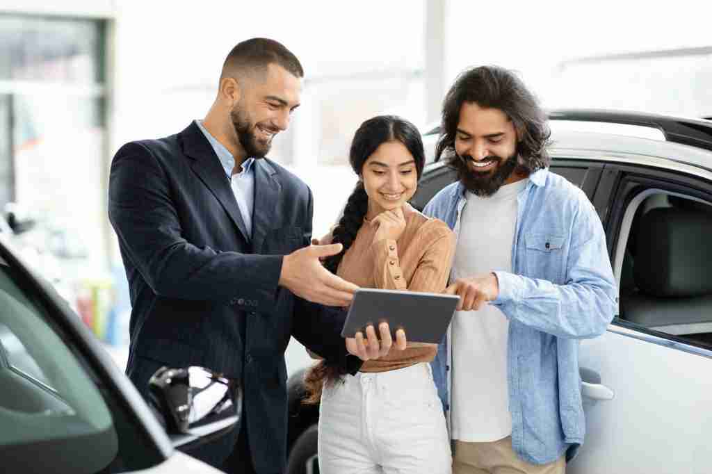 Salesperson showing tablet to customers