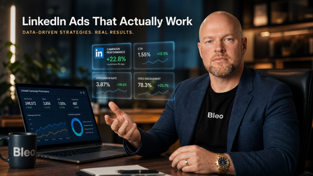 Professional marketer Luke Houlihan in a modern office presenting LinkedIn video ad analytics and conversion metrics on holographic displays, wearing Bleo branded clothing