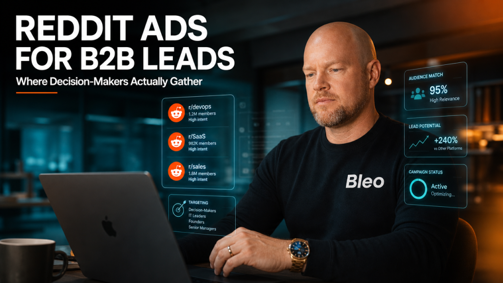 Professional man with confident expression reviewing Reddit ads targeting data with subreddit communities and B2B decision-maker metrics displayed on screen in modern office